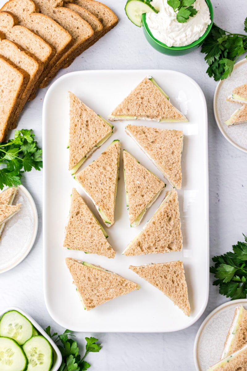 finger sandwiches displayed on a white platter