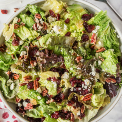 mixed green salad with apple cider vinaigrette in bowl