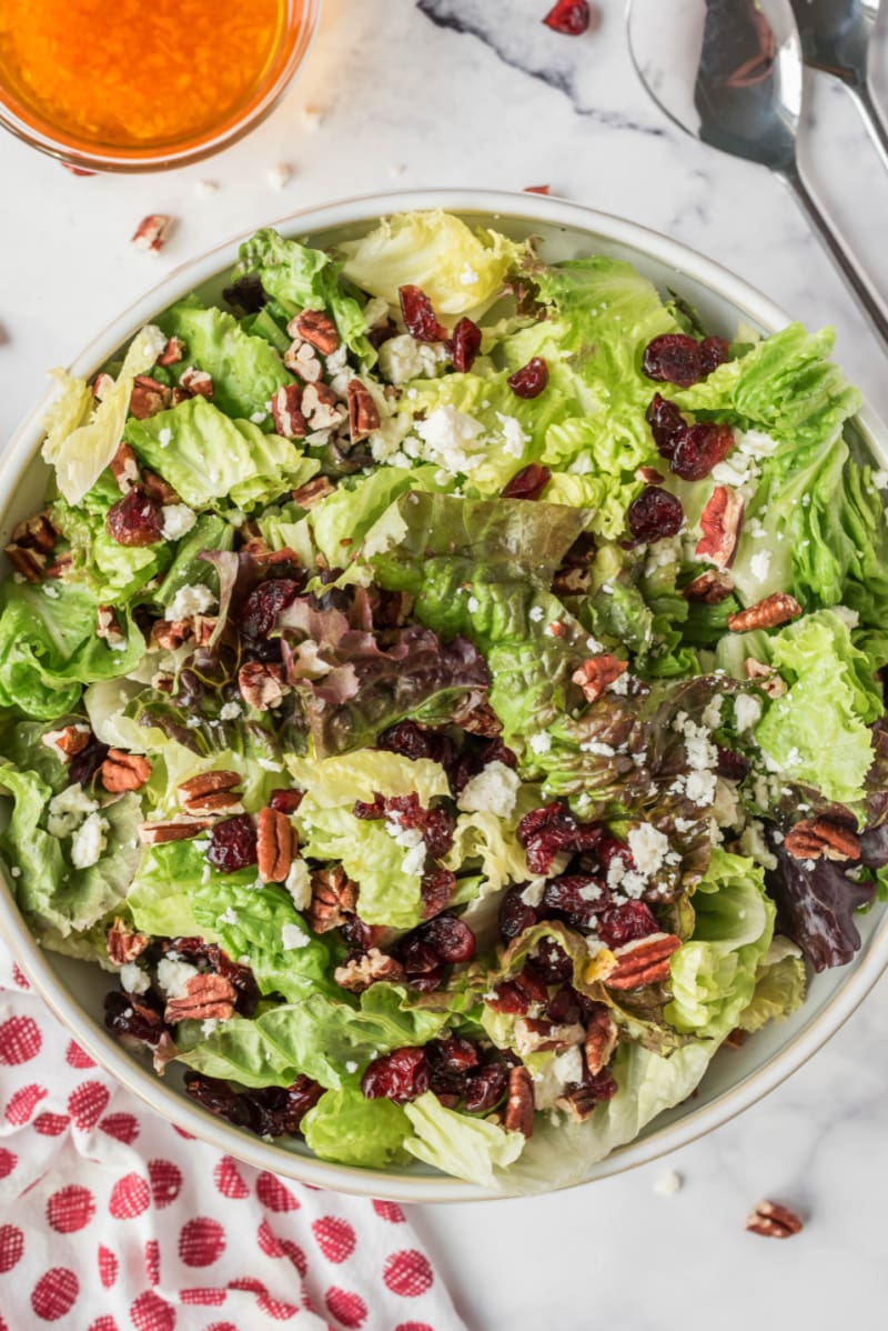 mixed green salad with apple cider vinaigrette in bowl