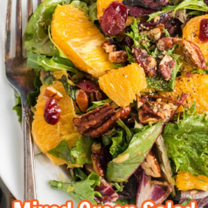 pinterest image for mixed green salad with oranges and dried cranberries