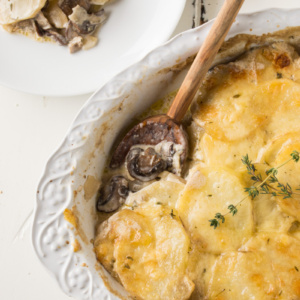 mushroom potato gratin with a wooden spoon