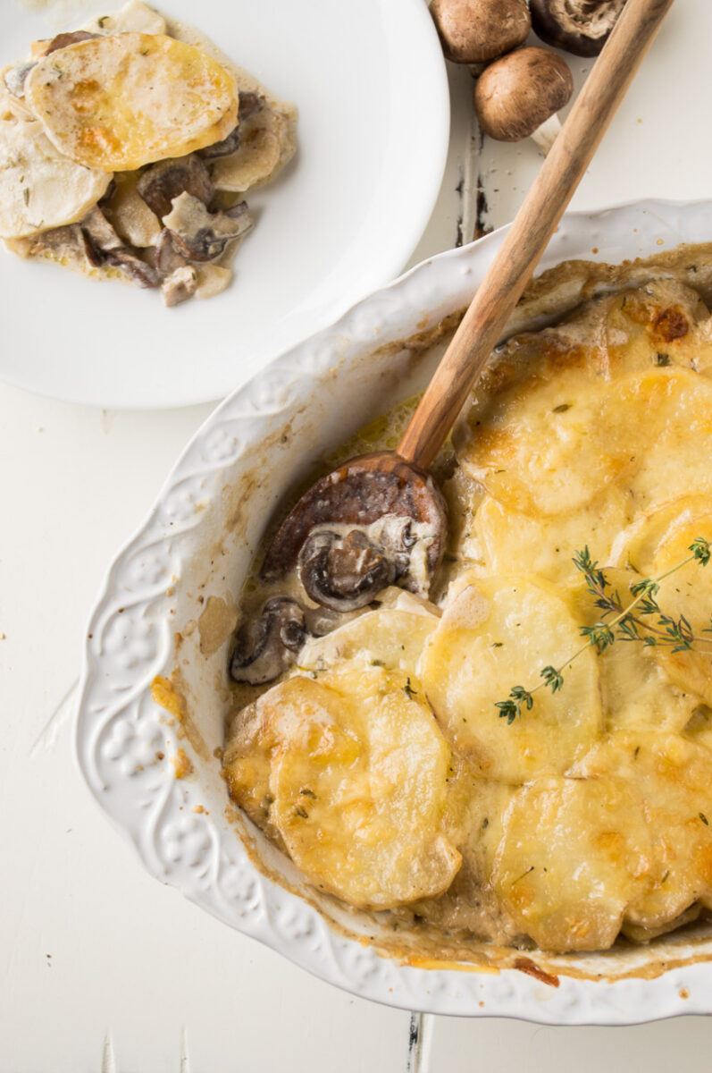 mushroom potato gratin with a wooden spoon