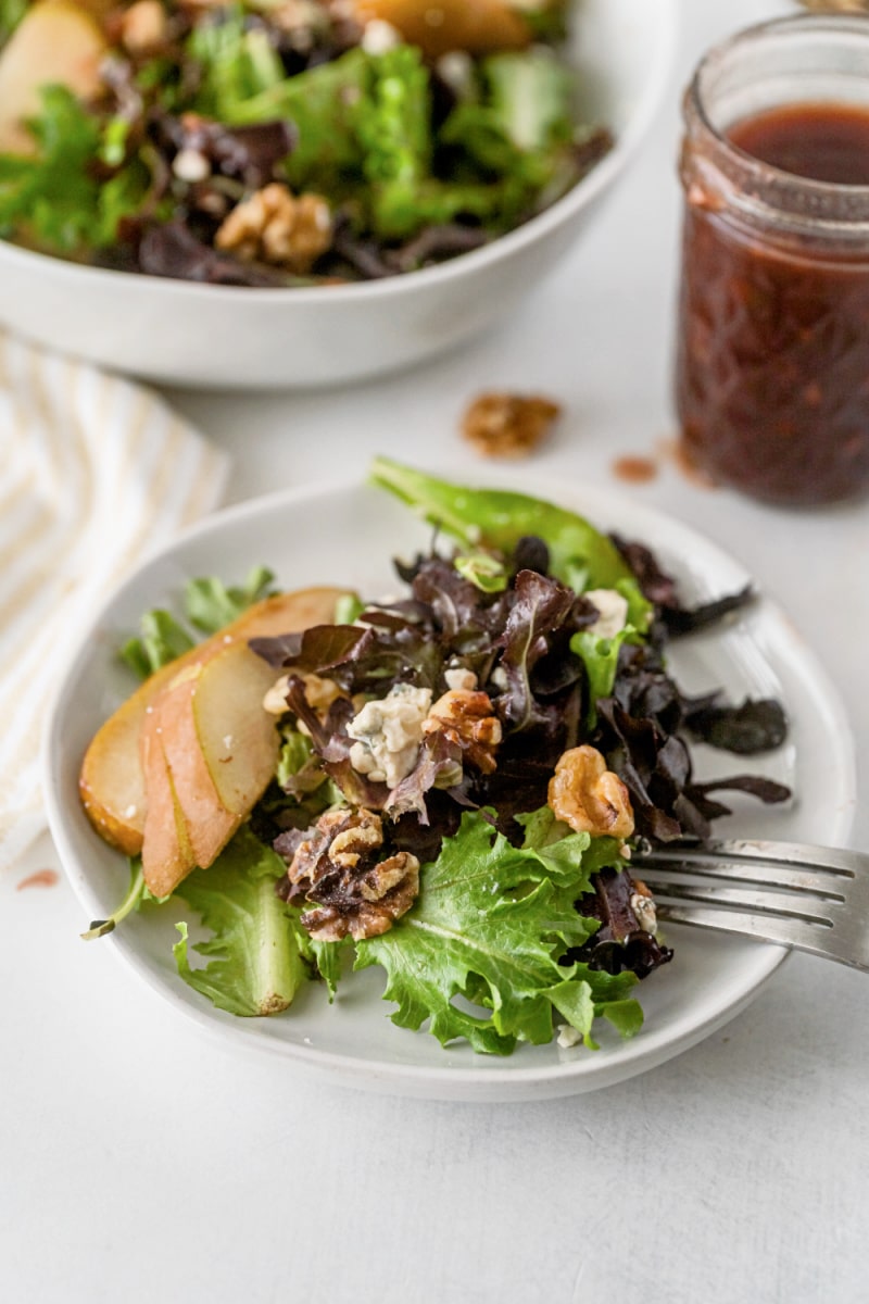 pear walnut and blue cheese salad on plate with fork