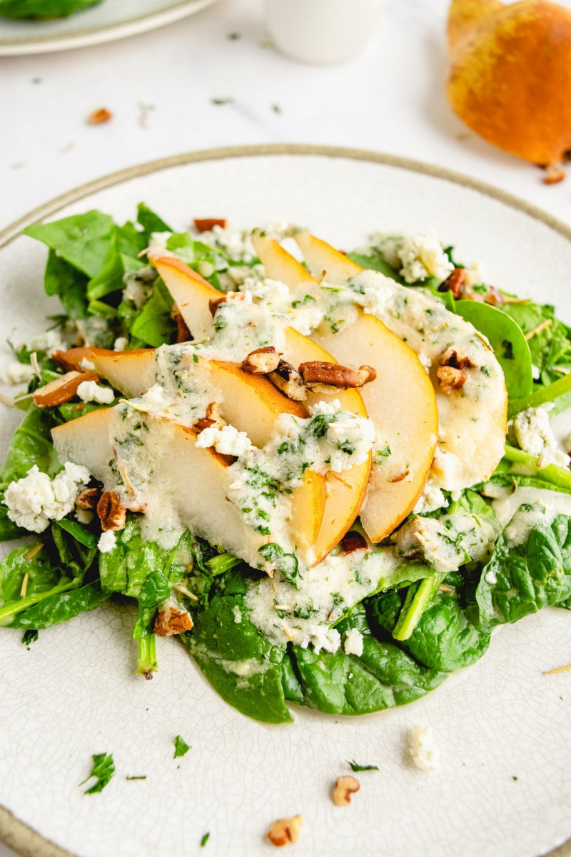 spinach and pear salad on white plate