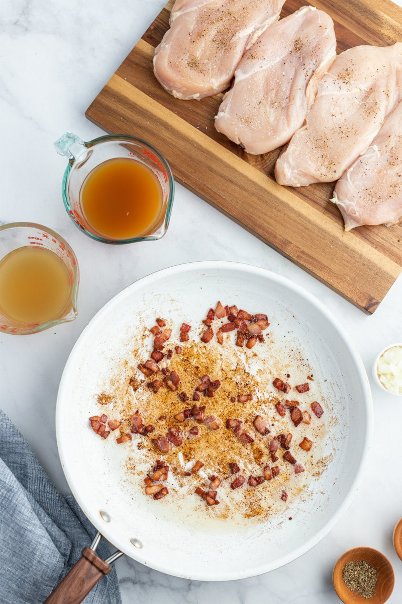 chicken on board and spices in bowl