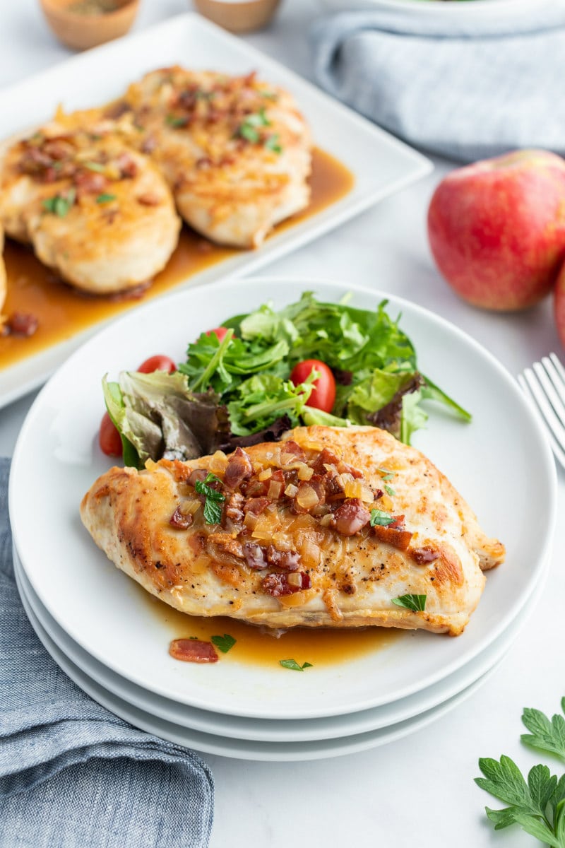 chicken with cider and bacon sauce plated with salad