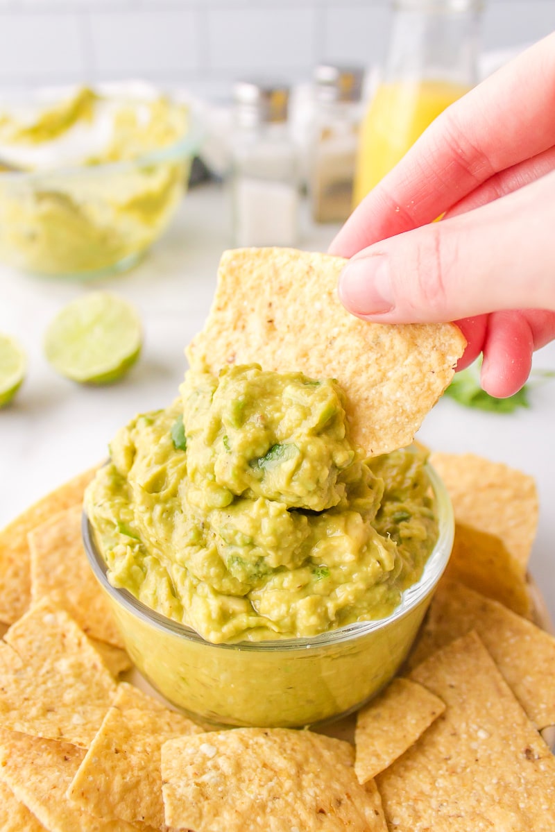 dipping a chip into guacamole