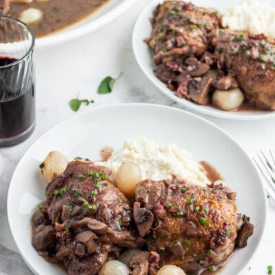 serving of coq au zin on white plates