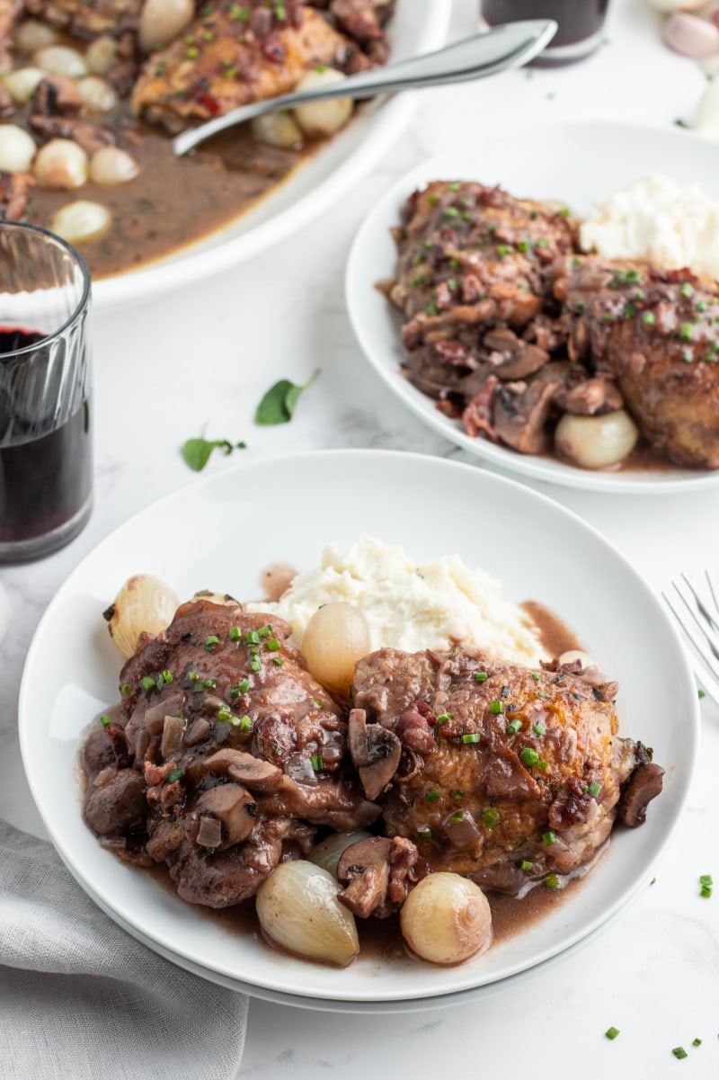 serving of coq au zin on white plates