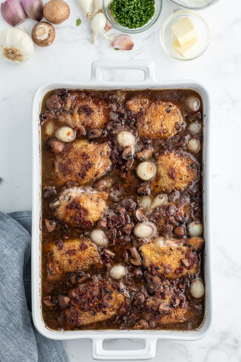 coq au zin in white casserole dish