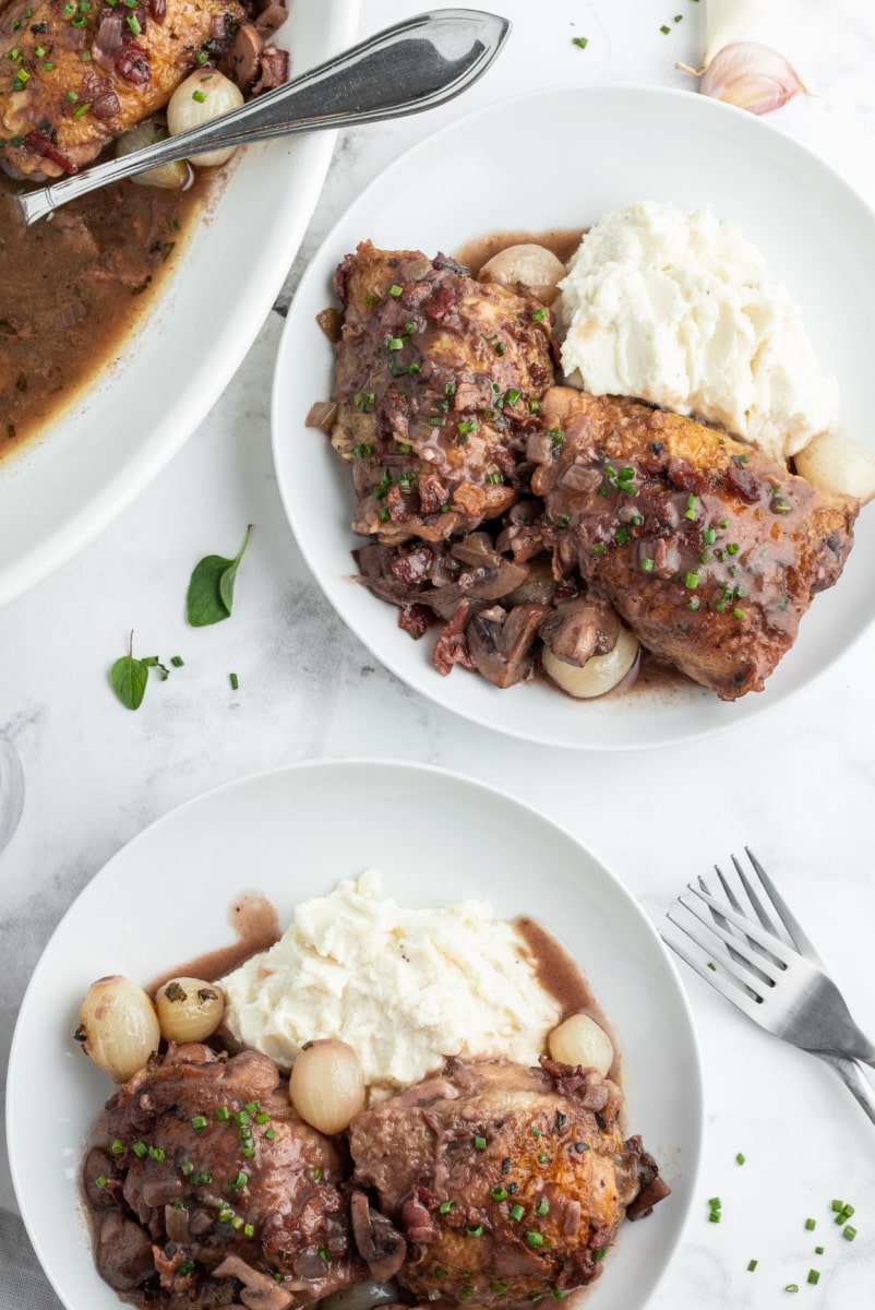 two servings of coq au zin on white plates