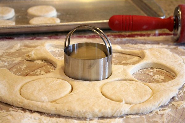 cutting biscuit dough with biscuit cutter