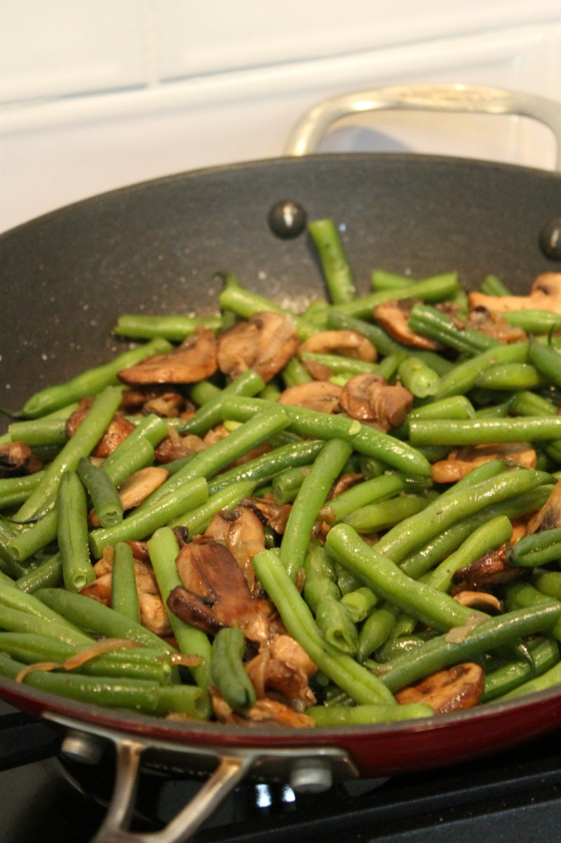 cooking Green Beans with Mushrooms and Shallots in a skillet