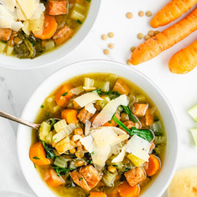 ham and lentil soup with spoon in white bowl