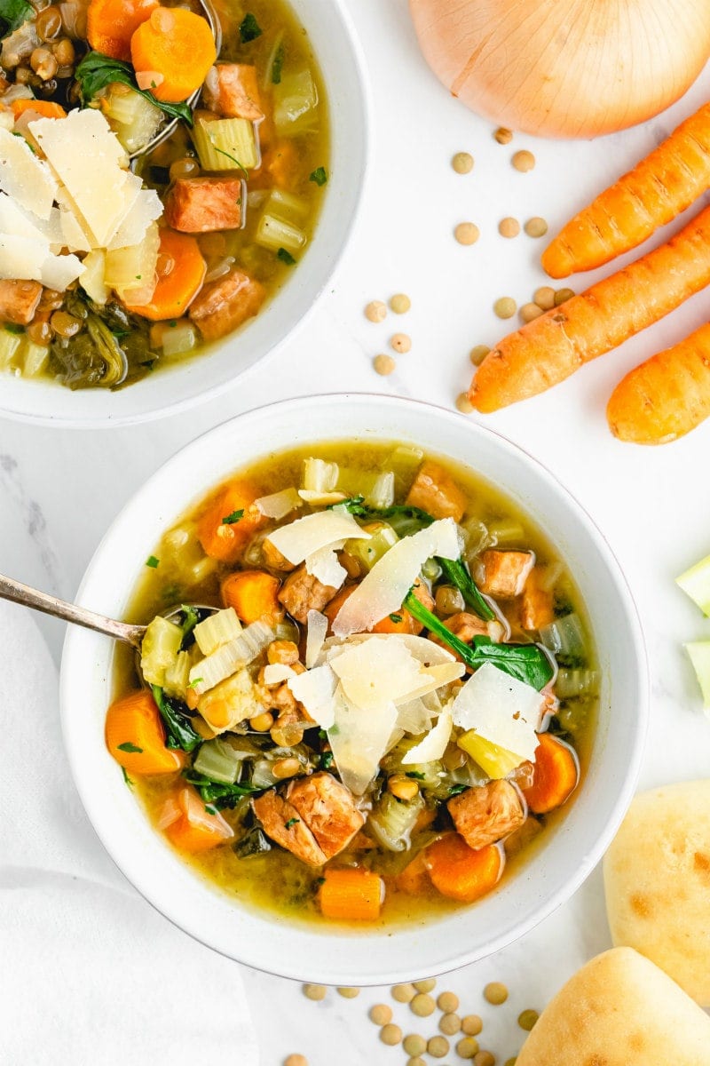 ham and lentil soup with spoon in white bowl