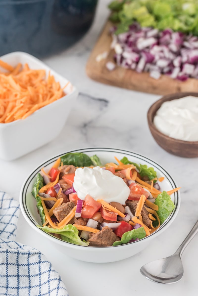 bowl of kick off chili with fixings