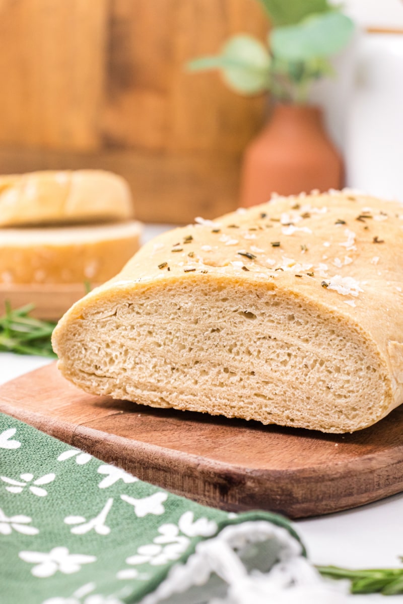 rosemary sea salt italian bread loaf cut open on cutting board