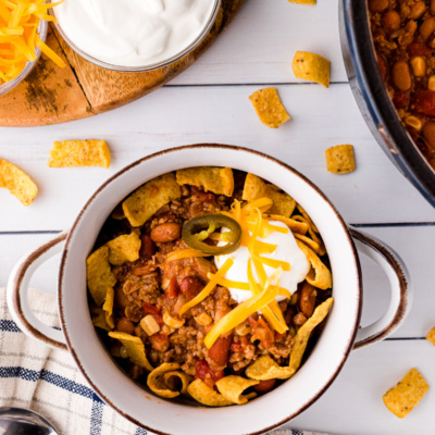 taco soup in a bowl topped with sour cream and shredded cheese