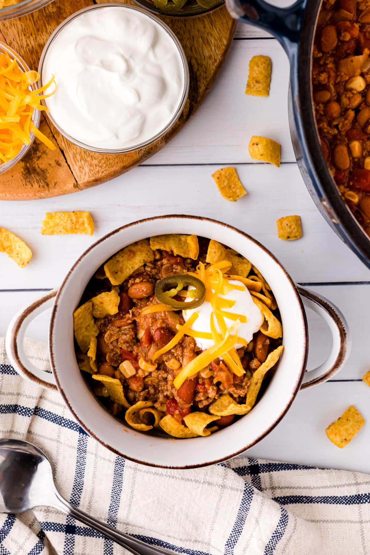 taco soup in a bowl topped with sour cream and shredded cheese