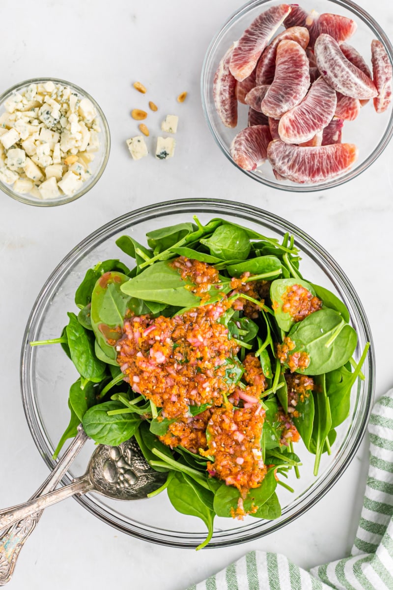 dressing sitting on top of spinach salad