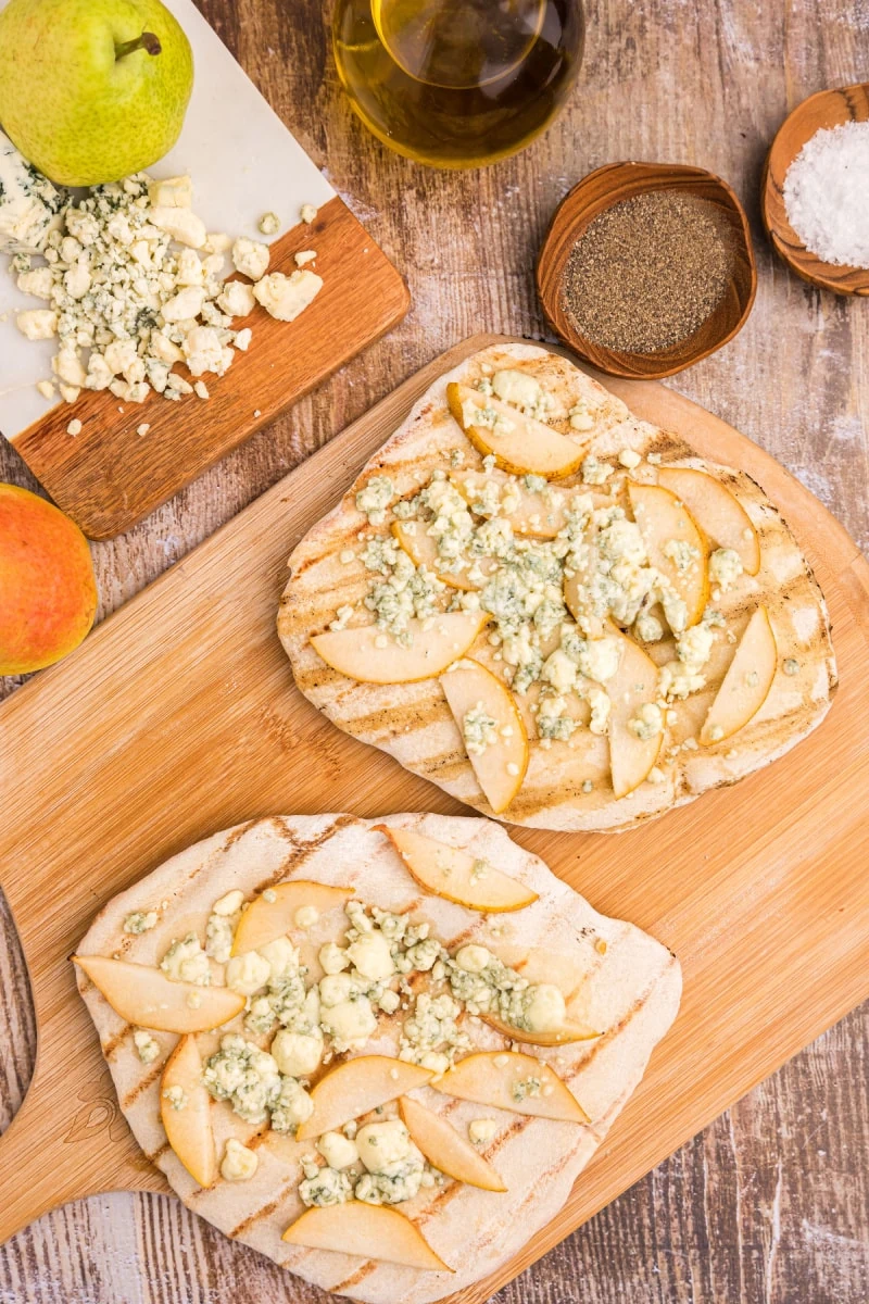 two grilled blue cheese and pear pizzas on board