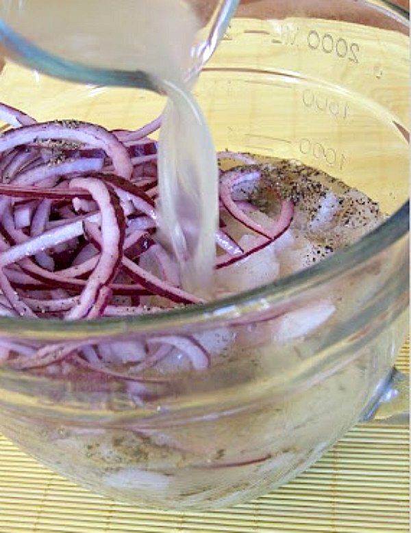 Salt and Pepper Ceviche pouring lime juice in bowl