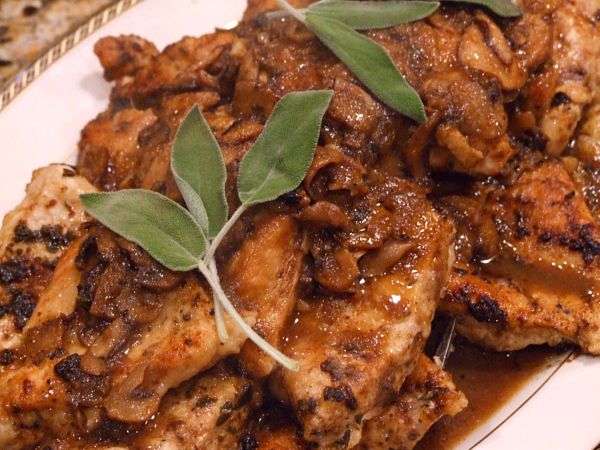 Chicken Marsala garnished with fresh sage