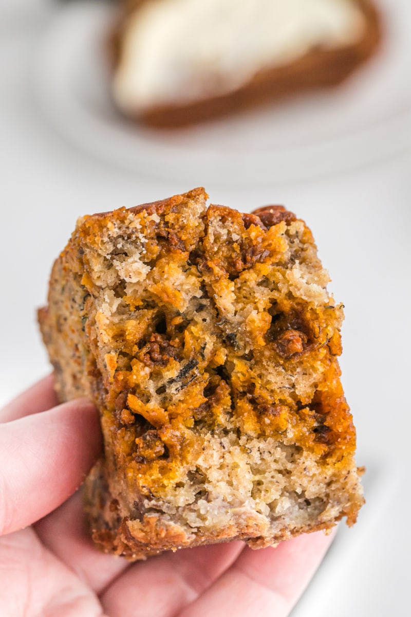 hand holding piece of cinnamon chip banana bread broken open to see inside