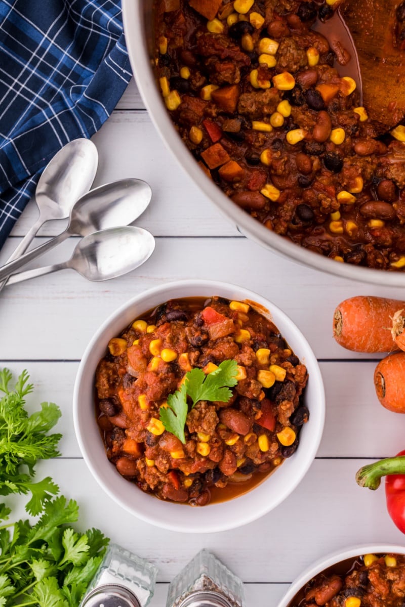 serving of confetti chili in bowl with pot in background