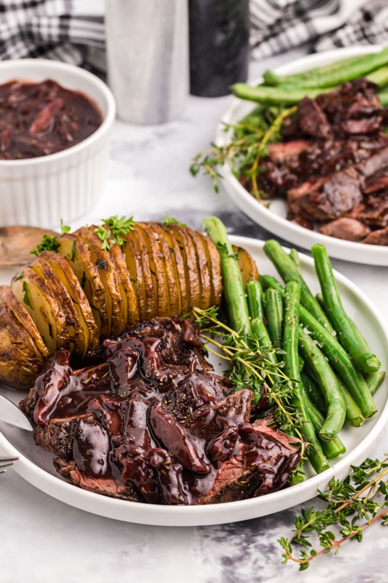 plate of filet mignon with mushroom cabernet sauce with potato and green beans