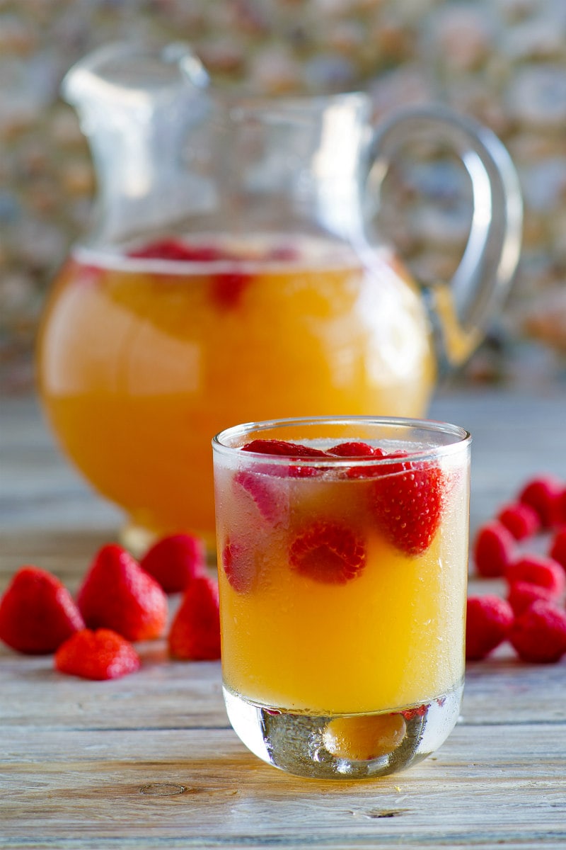 glass and pitcher of fruity vodka spritzers