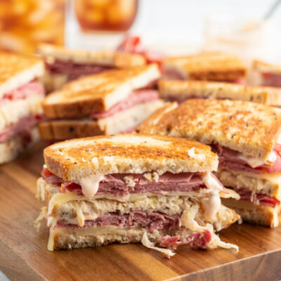 grilled reuben sandwiches on a cutting board