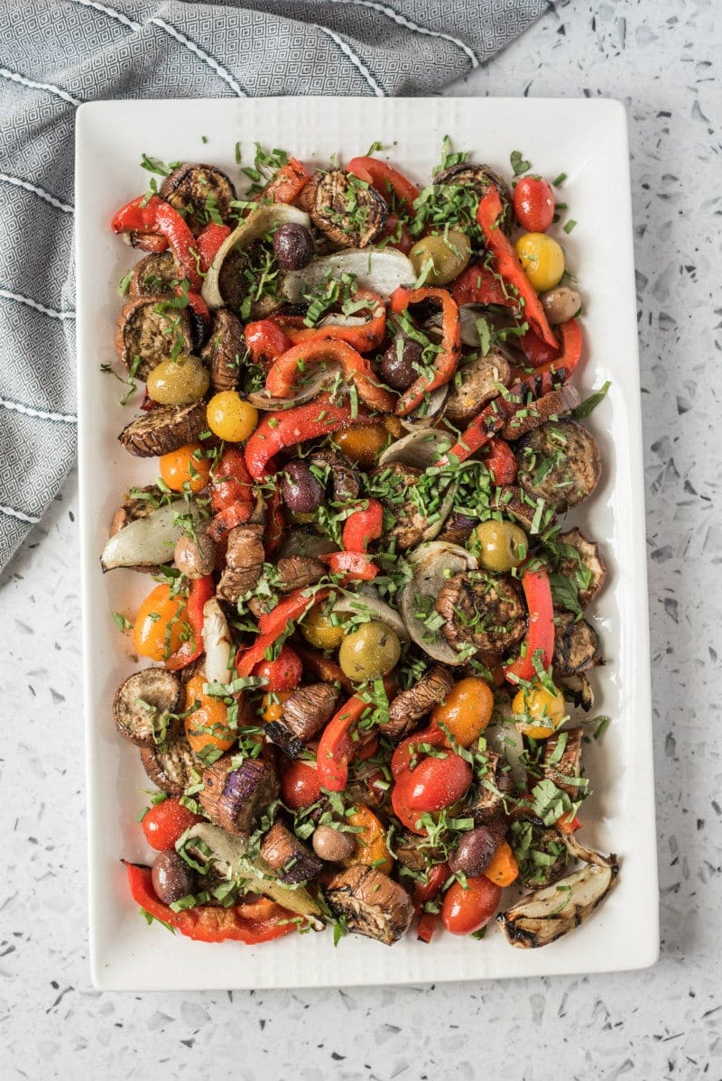 overhead shot of grilled vegetable salad on a rectangular white platter