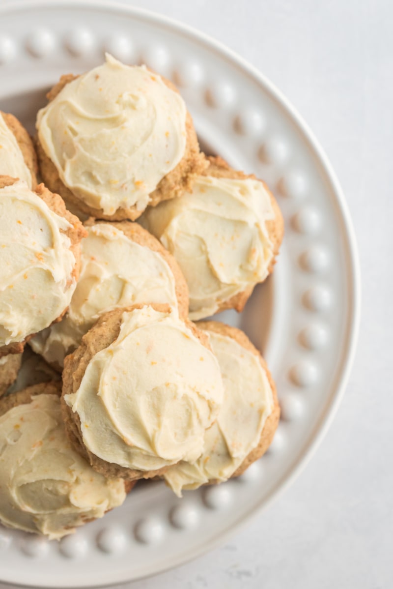 iced orange cookies on a white platter