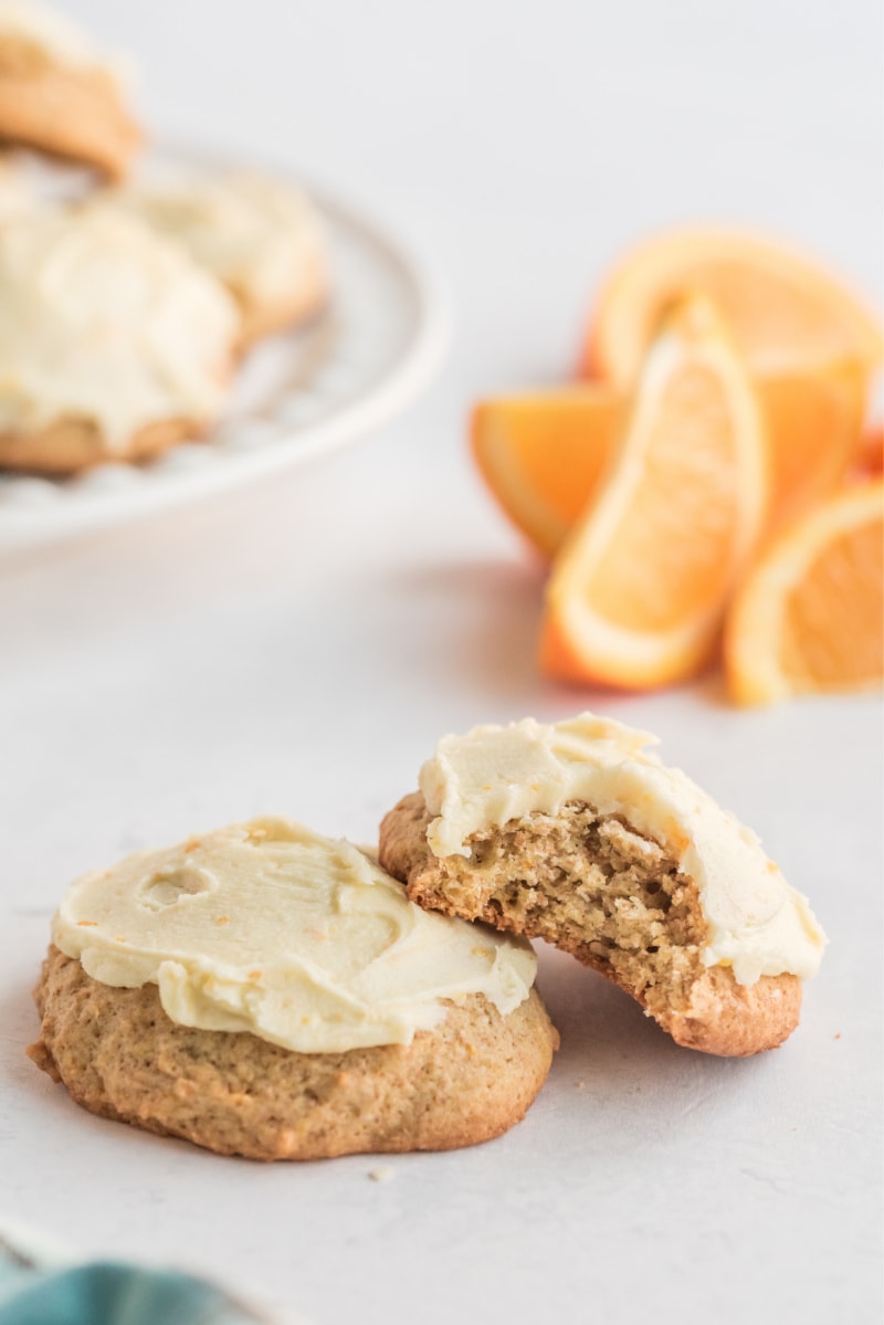 two orange cookies- one with a bite out of it