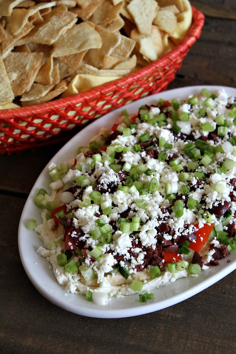 Layered Greek Dip served with pita chips