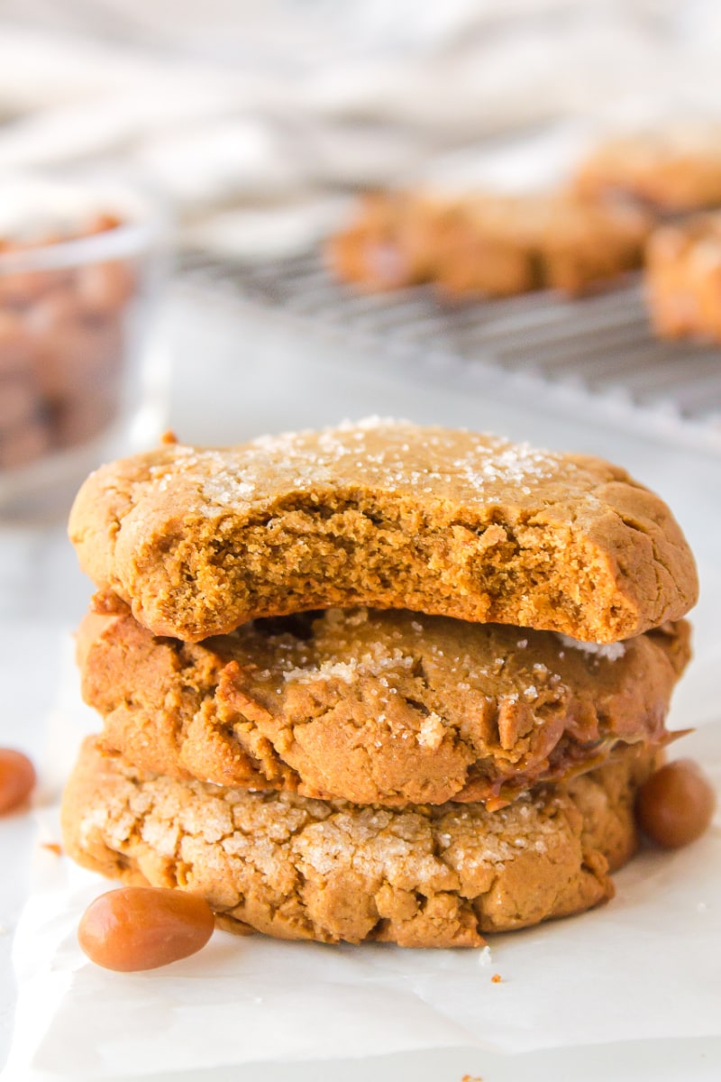 stack of three molasses cookies with the top one a bite taken out