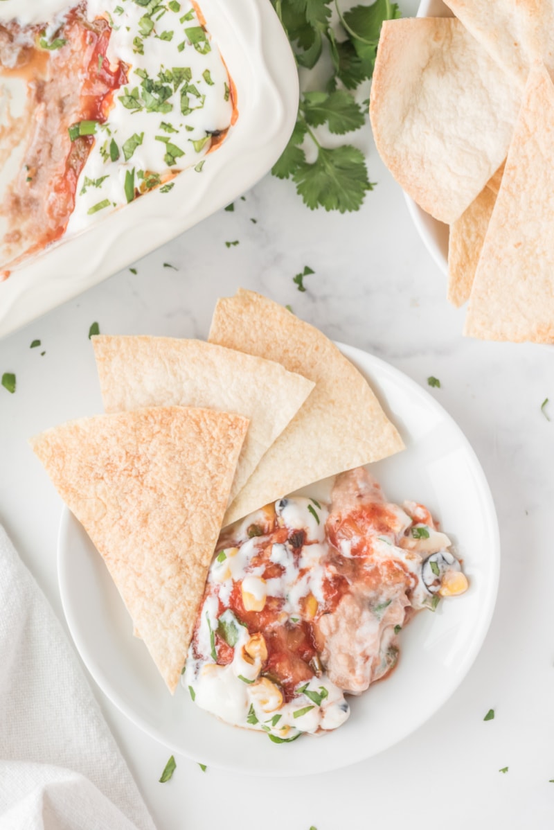 chips and party bean dip on a plate for serving