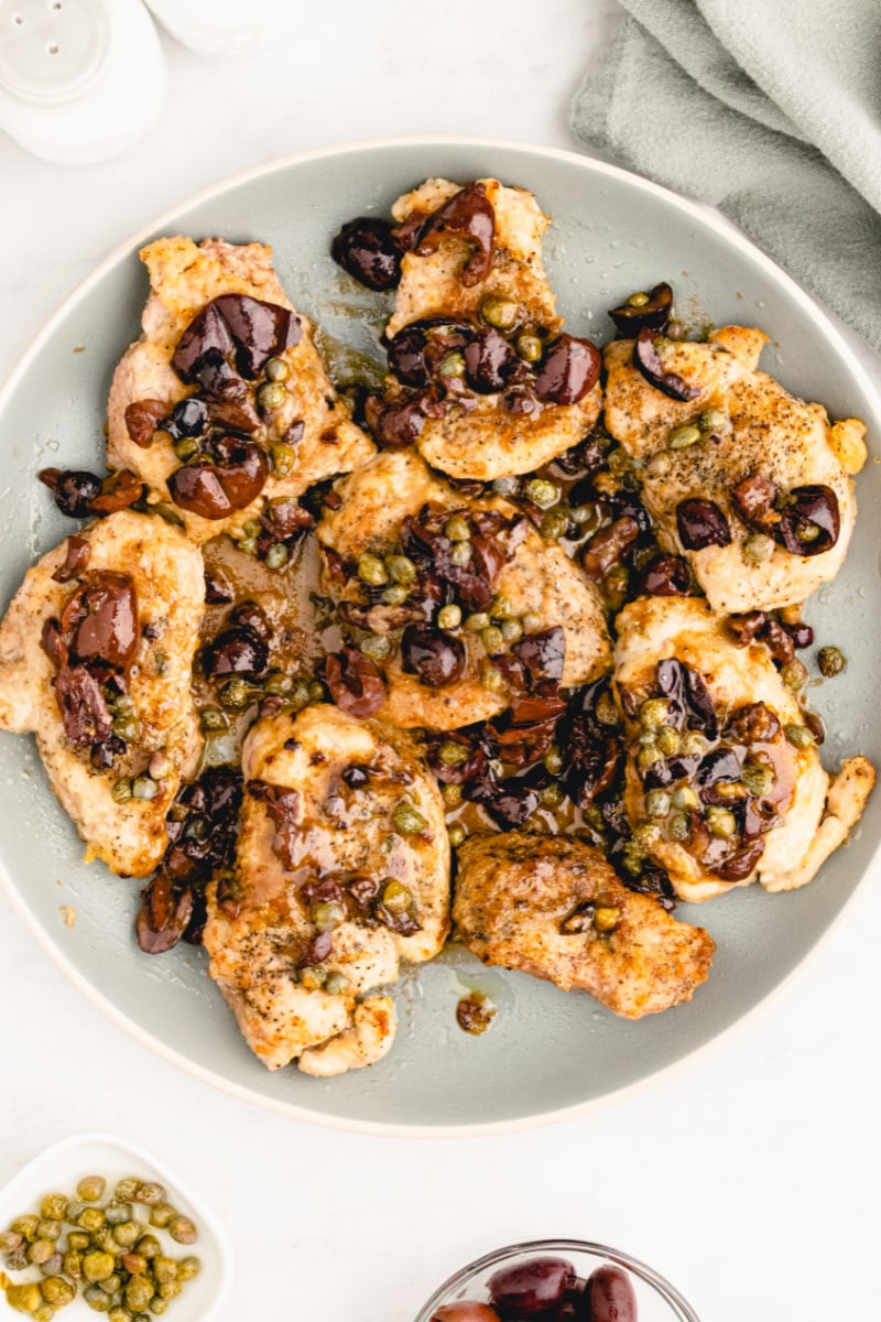 plate of pork medallions with olive caper sauce