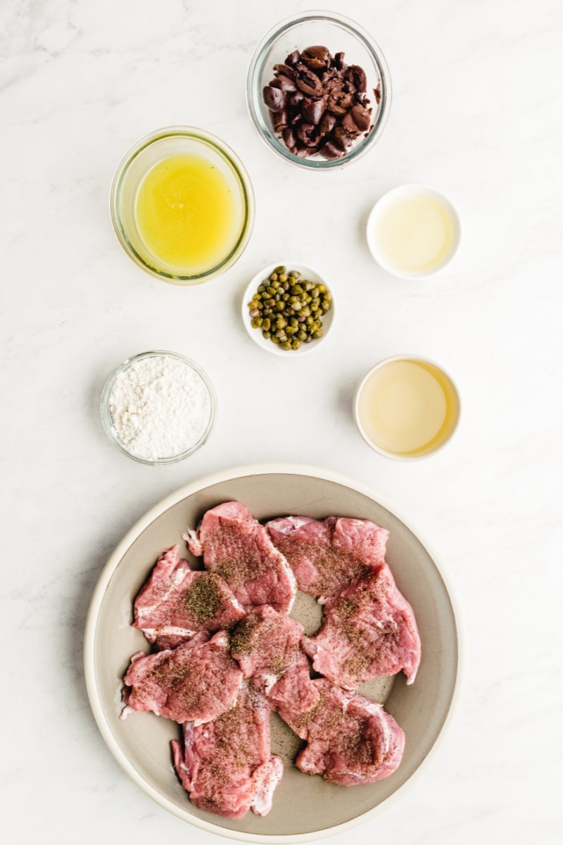 ingredients displayed for making pork medallions with olive caper sauce