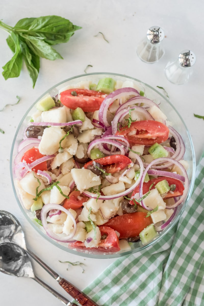 bowl of potato salad with olives tomatoes and capers
