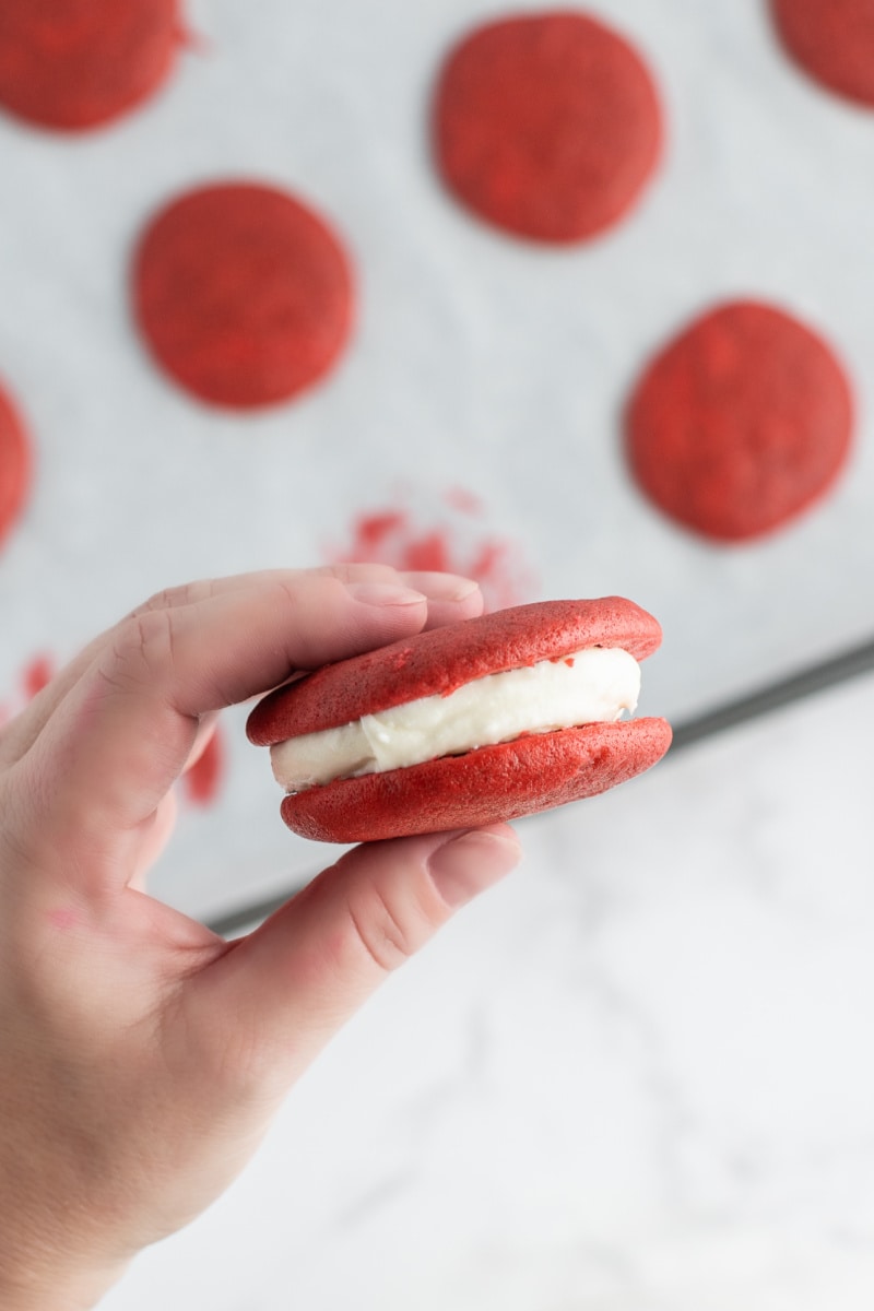 hand holding red velvet whoopie pie