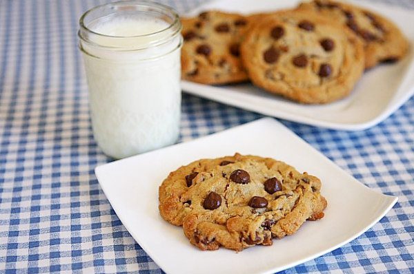 Reeses Stuffed Peanut Butter Chocolate Chip Cookies with a glass of milk