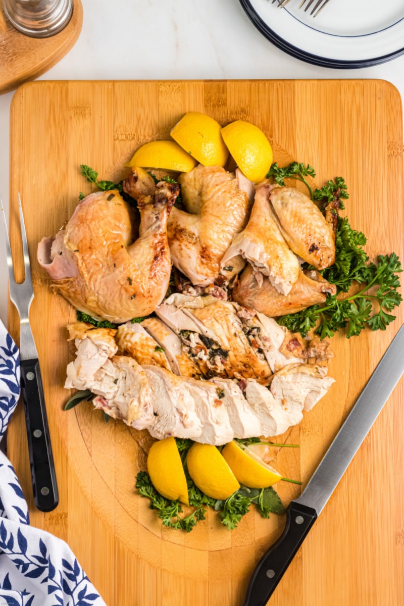 slashed chicken with bacon butter on a cutting board