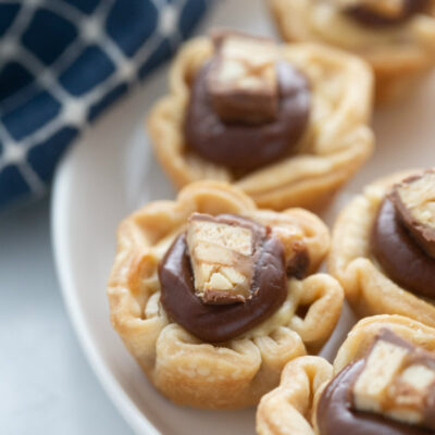 snickers bar mini tarts on a white platter
