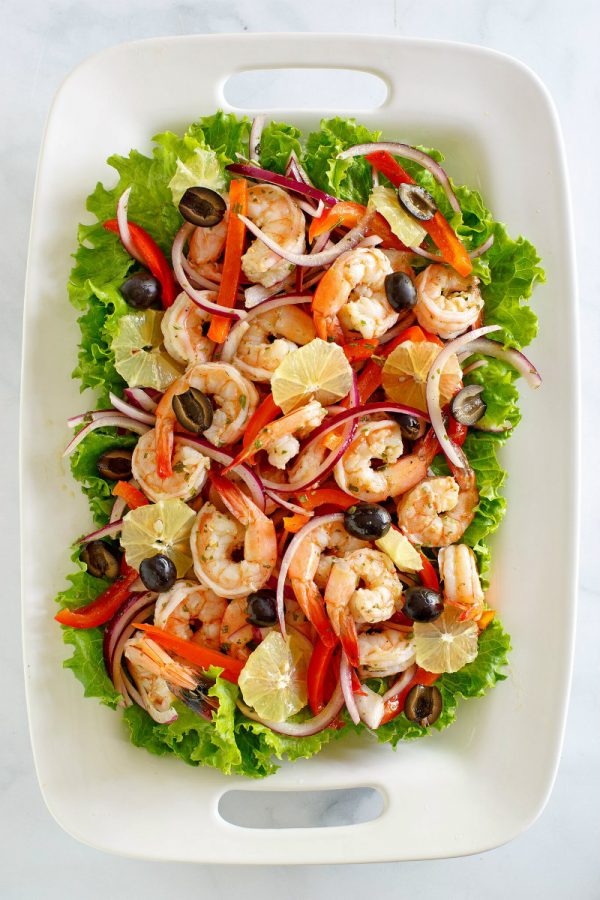 Spicy Lemon Shrimp Salad on a white platter edged with lettuce leaves