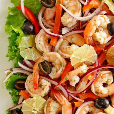 spicy lemon shrimp salad edged by lettuce leaves