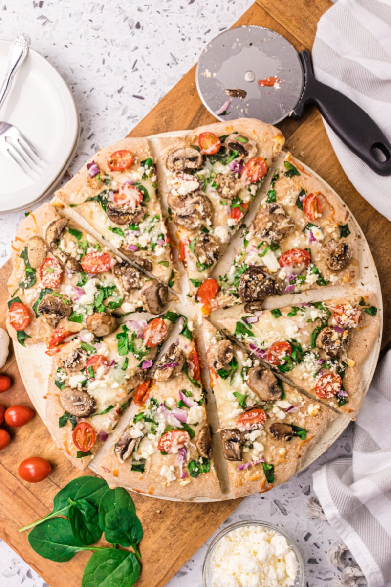 spinach mushroom and feta pizza cut into slices