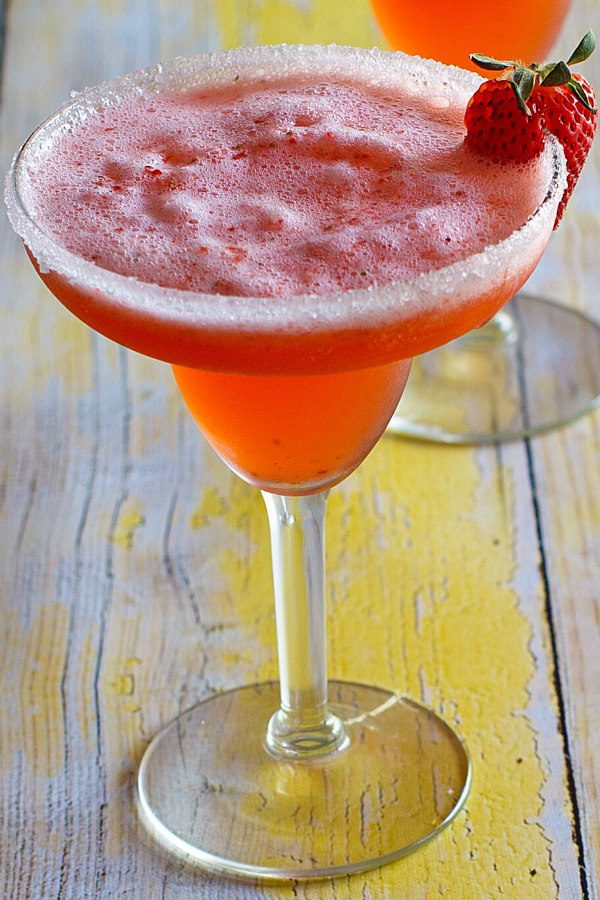 Strawberry Margarita in a margarita glass garnished with fresh strawberry