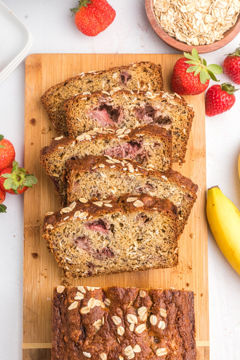 slices of strawberry oatmeal banana bread on board